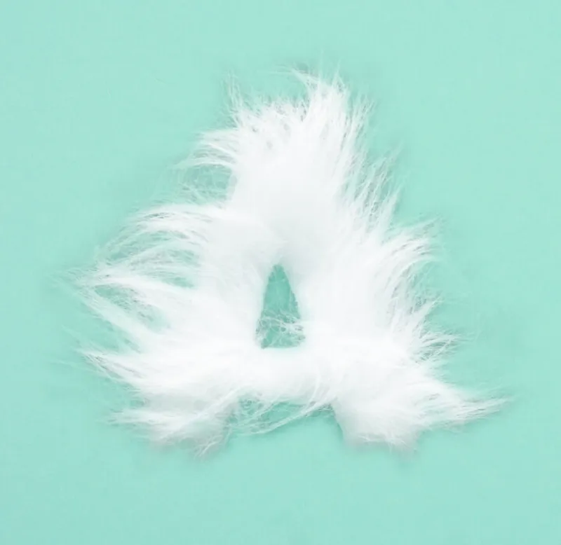 The letter 'A' intricately formed from soft, fluffy white fibers, resembling fur, set against a smooth light teal background. The design emphasizes texture and contrast, creating a visually striking and tactile appearance.